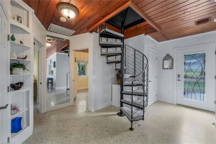 Foyer entrance featuring wooden ceiling and wooden walls