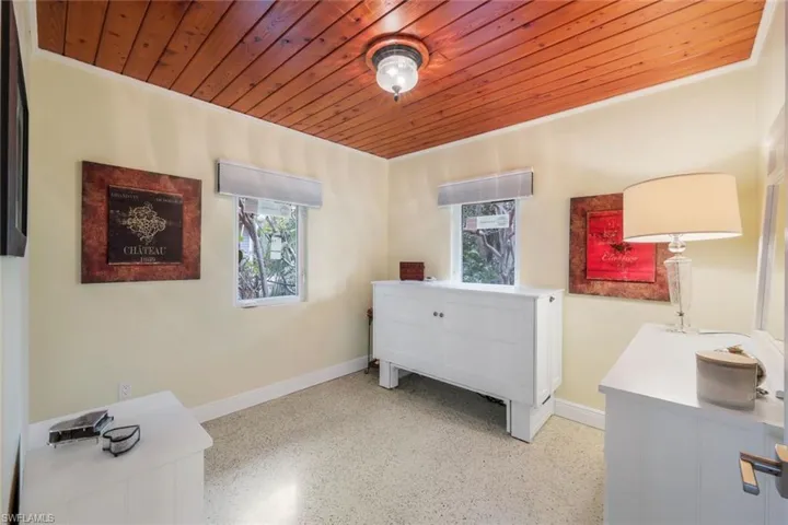 Bedroom with multiple windows and wooden ceiling