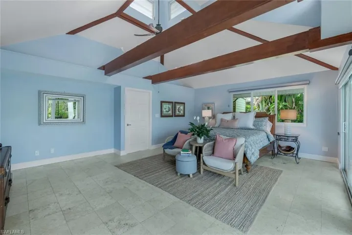 Primary Bedroom featuring multiple windows and vaulted ceiling with beams & cupola