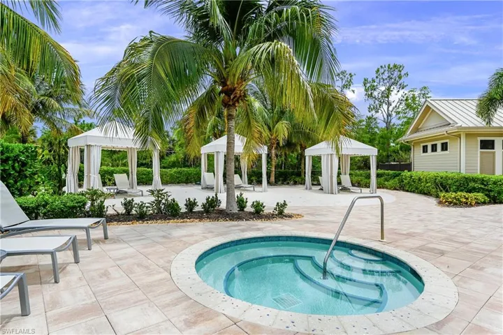 View of swimming pool featuring a patio area, an in ground hot tub, and a gazebo