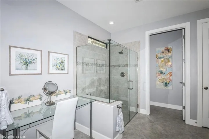 Bathroom with walk in shower and tile patterned floors