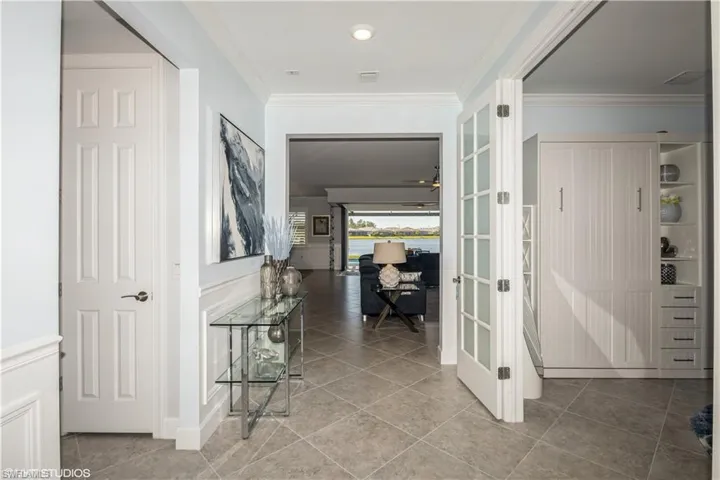 Hall featuring ornamental molding and tile patterned flooring