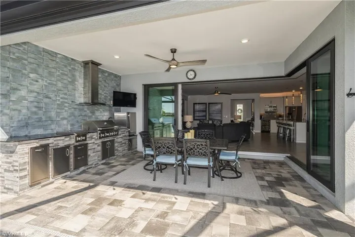 View of patio with ceiling fan, grilling area, and area for grilling