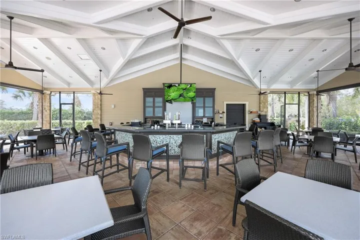 Tiled dining space featuring beamed ceiling and ceiling fan