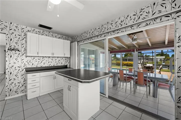 Coffee bar, island, and access to the sunroom