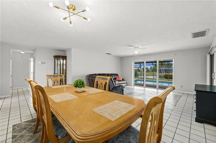 From the dining area looking through the living room to the pool