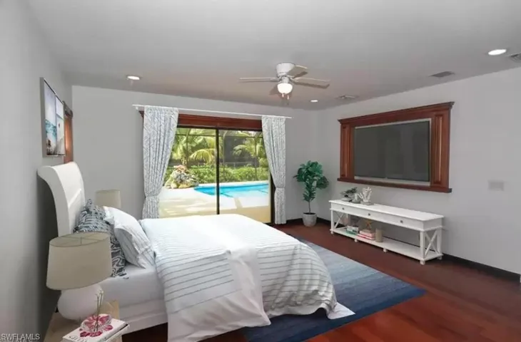 Bedroom with access to exterior, dark wood-style flooring, and ceiling fan