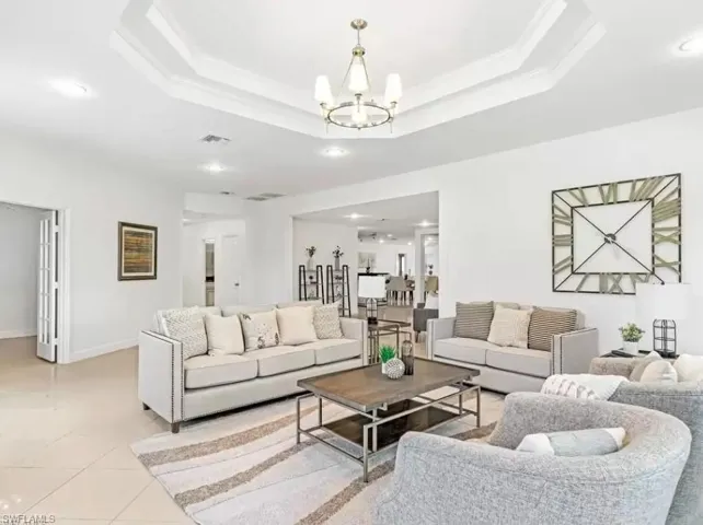 Tiled living room featuring recessed lighting