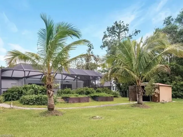 View of community featuring a sunroom and a yard