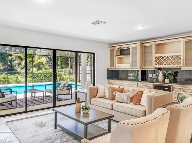 Living area with recessed lighting and light tile patterned floors