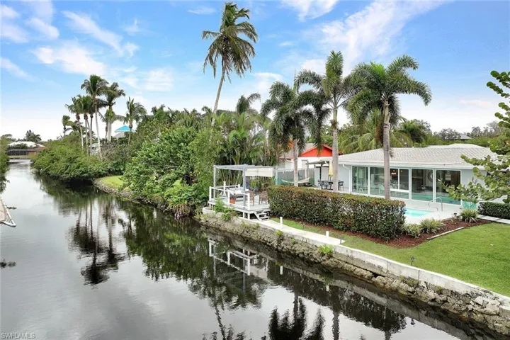 PLENTY of room for a boat lift! Notice the wide canal and seawall.