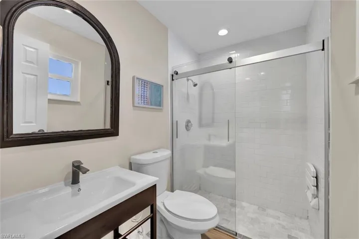 Updated guest bathroom features a walk-in shower.