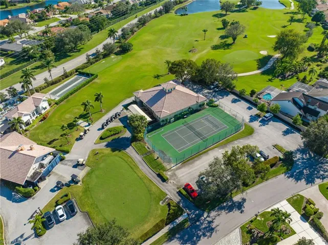 Aerial view of property's location featuring a local golf course and a large body of water
