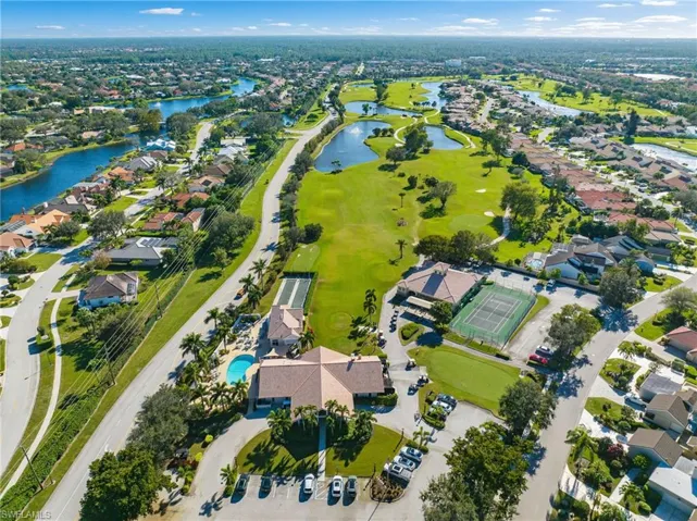 View of property location with nearby suburban area, a large body of water, and a golf club