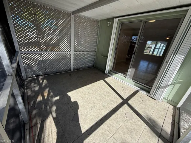 Unfurnished sunroom featuring a balcony
