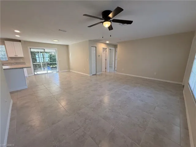 Unfurnished living room with a ceiling fan, recessed lighting, and light tile patterned floors