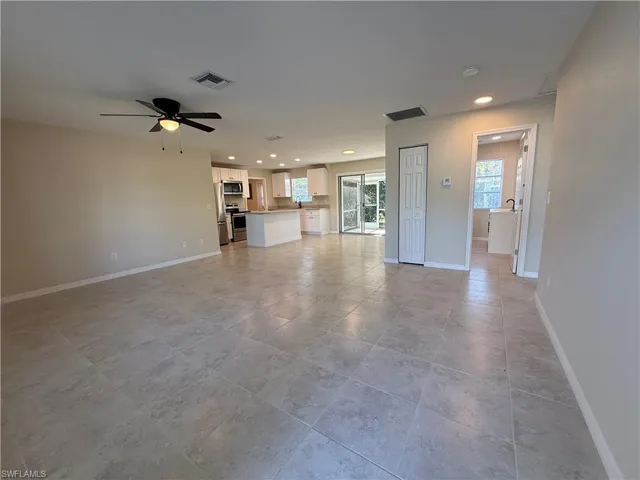 Unfurnished living room featuring a ceiling fan and recessed lighting