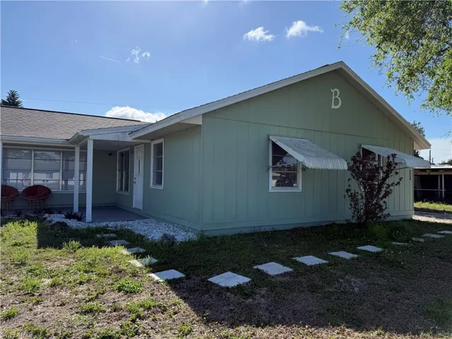 View of home's exterior featuring a patio area and a lawn