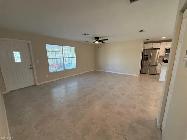 Unfurnished living room with a ceiling fan, light tile patterned floors, and recessed lighting