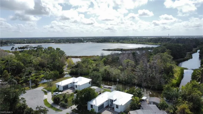 Birds eye view of property with a water view