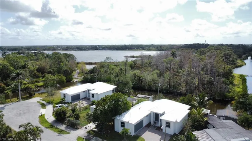 Birds eye view of property with a water view