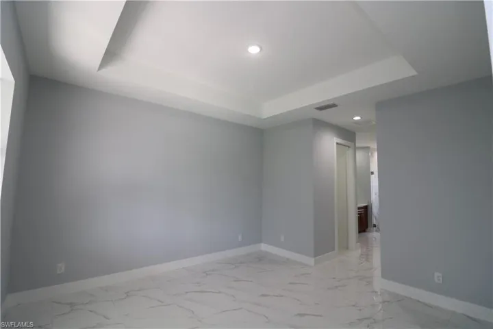 Empty room with a raised ceiling