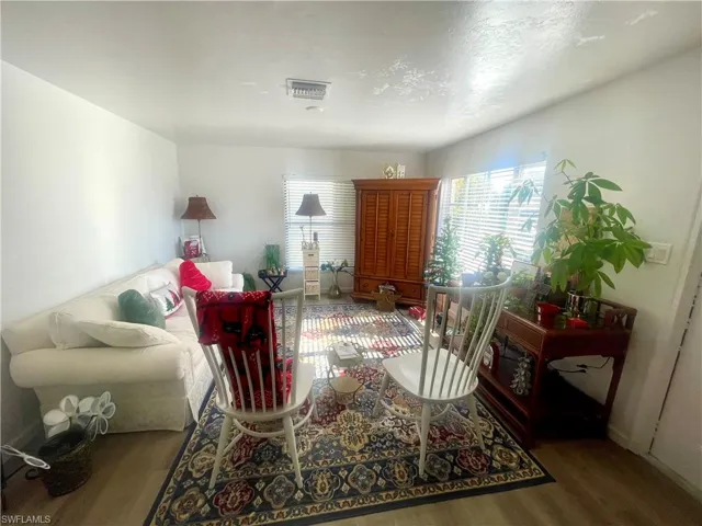 Living area with wood finished floors and a textured ceiling