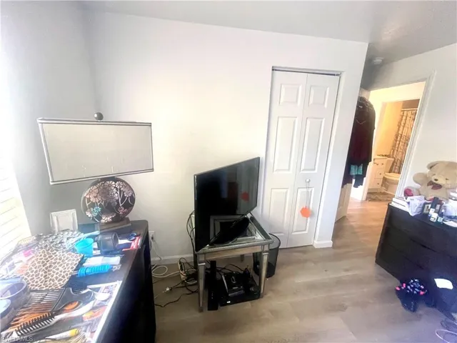 Bedroom featuring a closet, wood finished floors, and ensuite bathroom