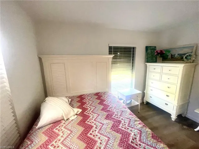 Bedroom with dark wood-style flooring