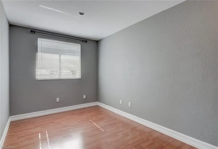 Den with wood-type flooring