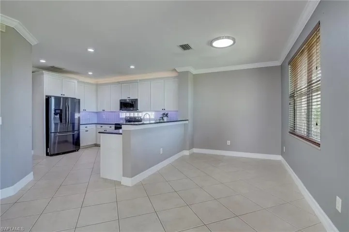 Kitchen with stainless steel appliances, kitchen peninsula, and white cabinets