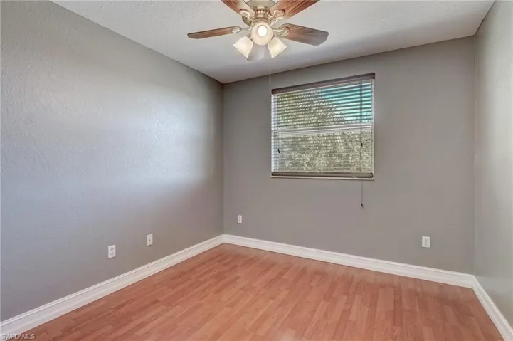 Spare room with ceiling fan, a textured ceiling, and light wood-type flooring