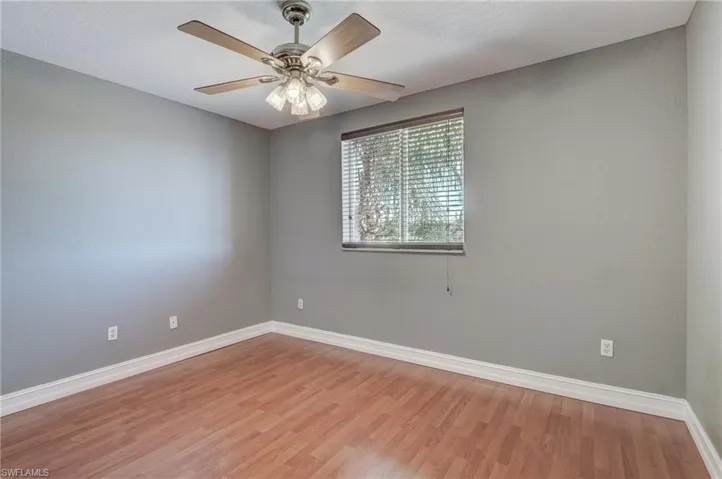 Spare room featuring ceiling fan and light wood-type flooring