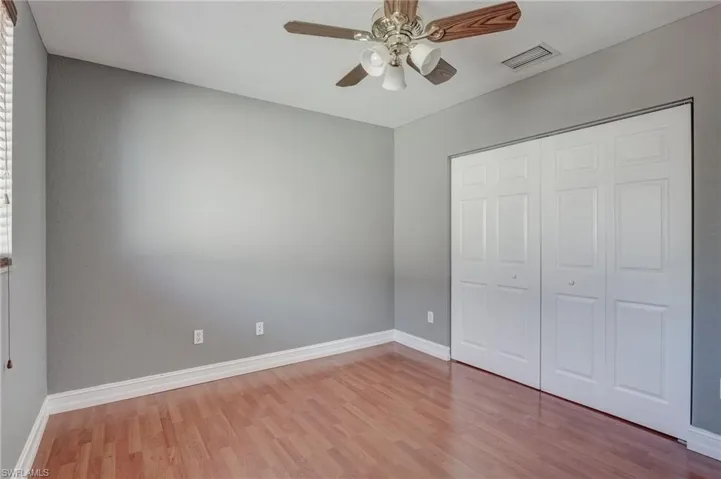 Bedroom featuring light hardwood / wood-style flooring, a closet, and ceiling fan