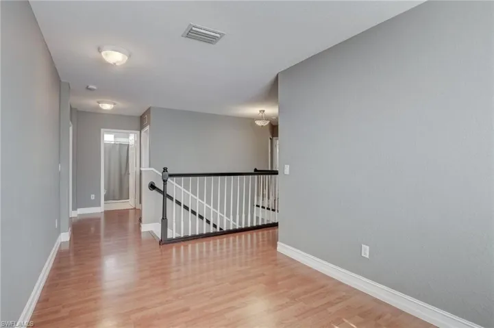 Corridor featuring hardwood / wood-style flooring