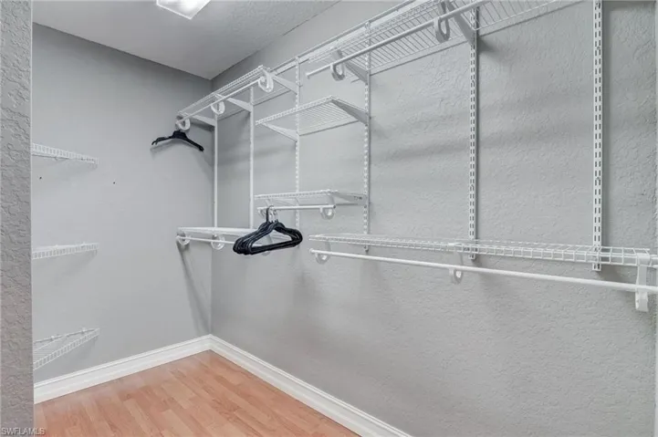 Walk in closet featuring wood-type flooring