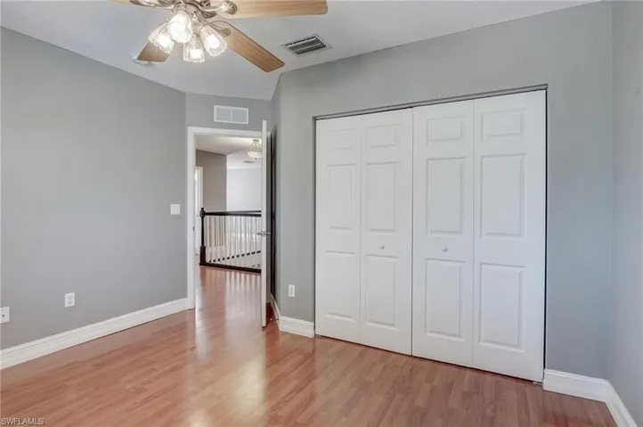 Bedroom featuring light hardwood / wood-style floors, a closet, and ceiling fan
