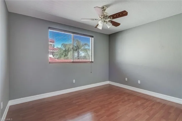 Spare room with hardwood / wood-style flooring, ceiling fan, and a textured ceiling
