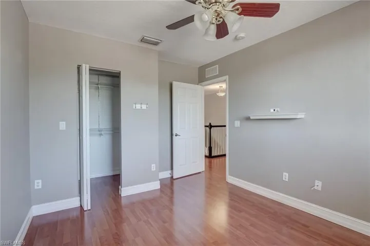 Bedroom featuring hardwood / wood-style floors, ceiling fan, and a closet