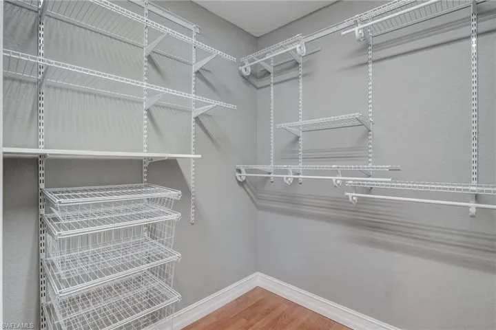 Walk in closet featuring wood-type flooring