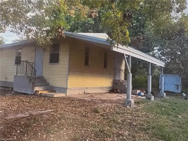 View of side of home with a shed