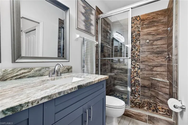 Bathroom with vanity and a stall shower