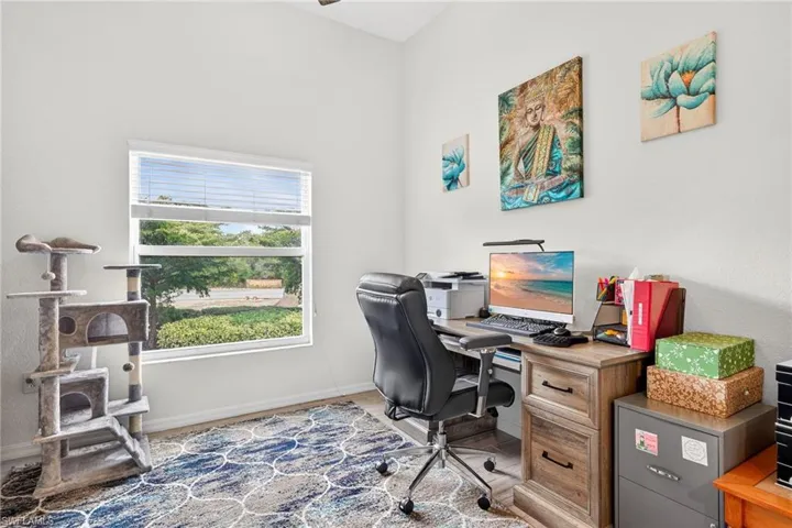 Office with wood finished floors and baseboards