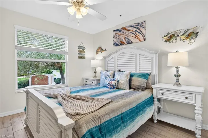 Bedroom with light wood-style flooring and a ceiling fan
