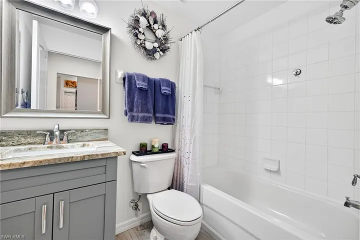 Bathroom with shower /bath combo with shower curtain and vanity