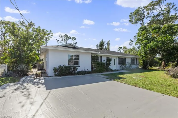 Ranch-style house featuring a front lawn and cooling unit