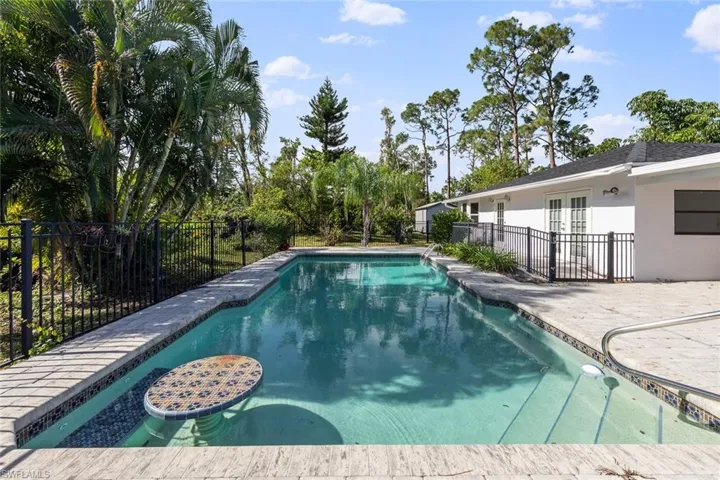 View of swimming pool featuring french doors and a patio area