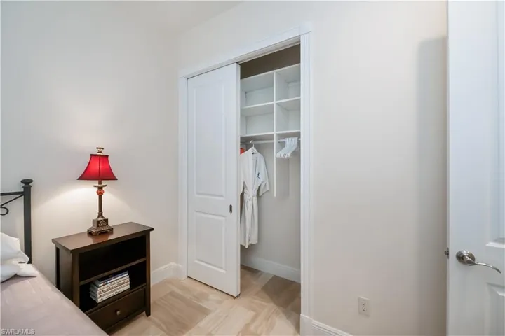 Guest Bedroom with custom shelving in closet