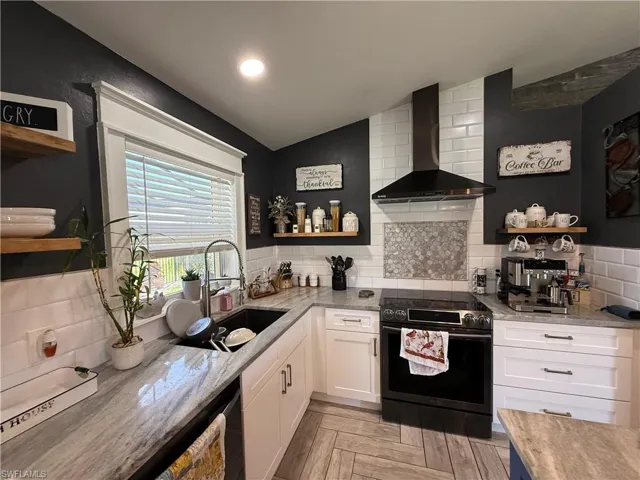 Kitchen with open shelves, backsplash, white cabinets, range with electric cooktop, and lofted ceiling