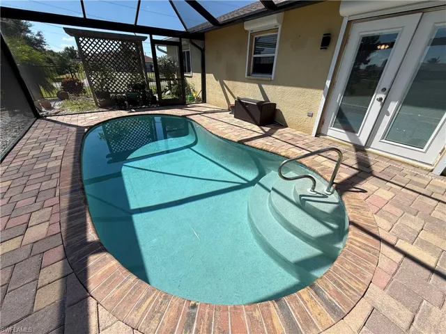 Outdoor pool with a patio area, a lanai, and a sunroom